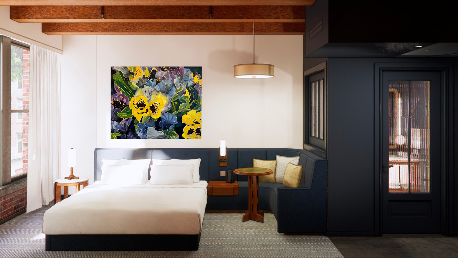 Interior of a King Room at Populus Seattle featuring a plush king-size bed with white linens, a cozy built-in navy banquette with a round wood table, large floral artwork above the headboard, exposed ceiling beams, and a mix of modern and natural textures throughout the space.