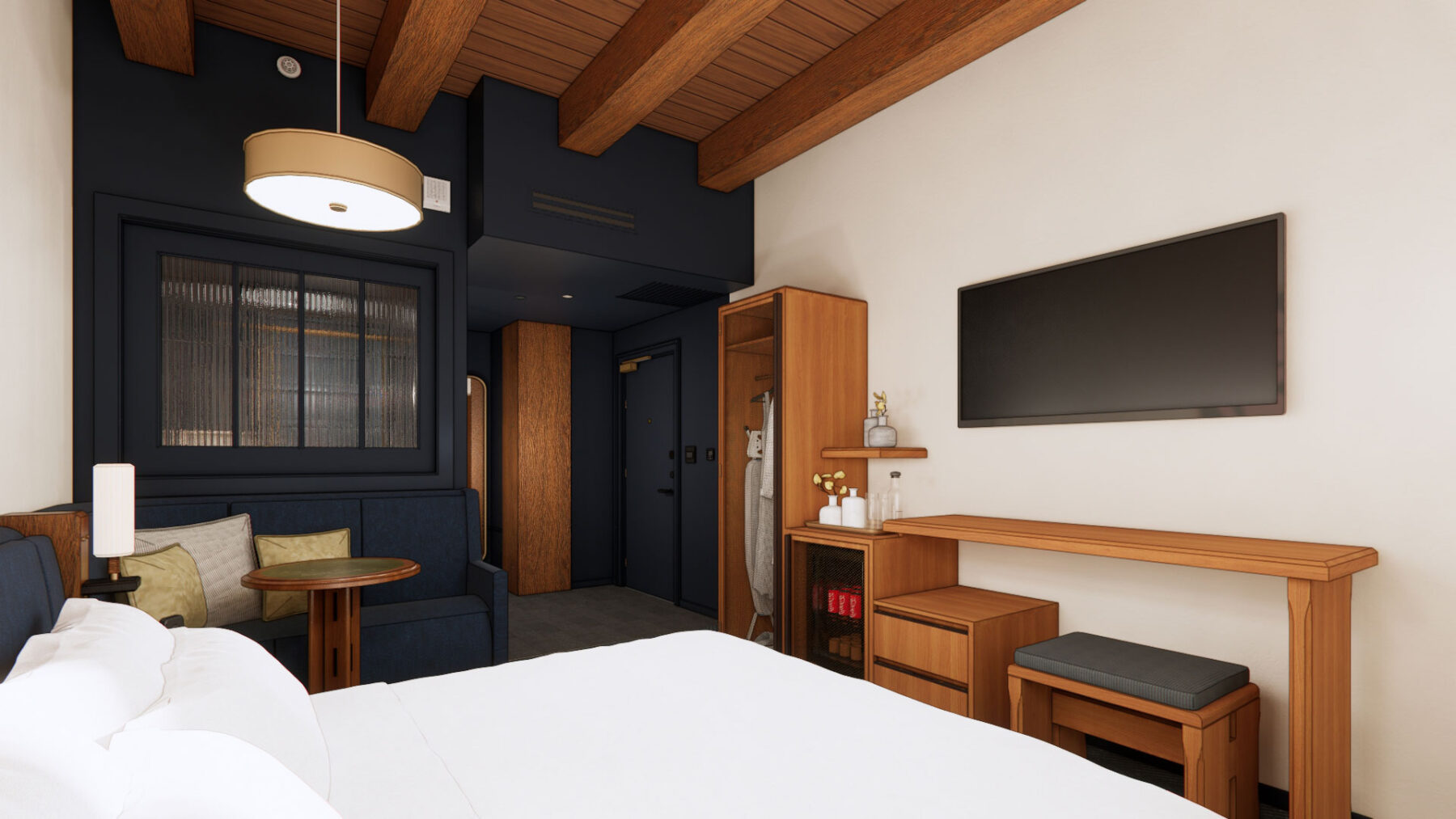 Populus Seattle king guest room interior featuring wood accents, built-in media wall, and cozy seating area