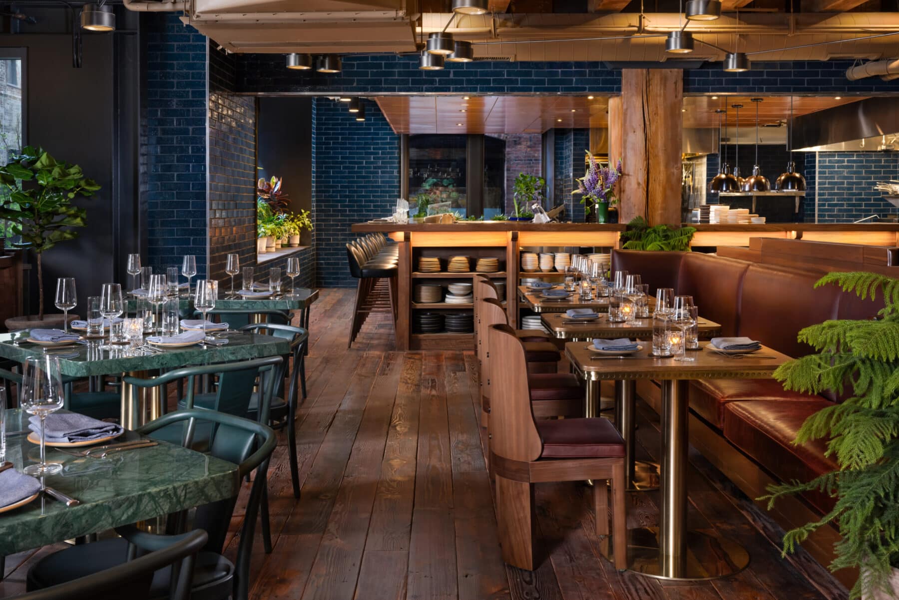 Spacious, art-filled dining area at Populus Seattle with wood beam ceilings, modern furnishings, and colorful contemporary artwork
