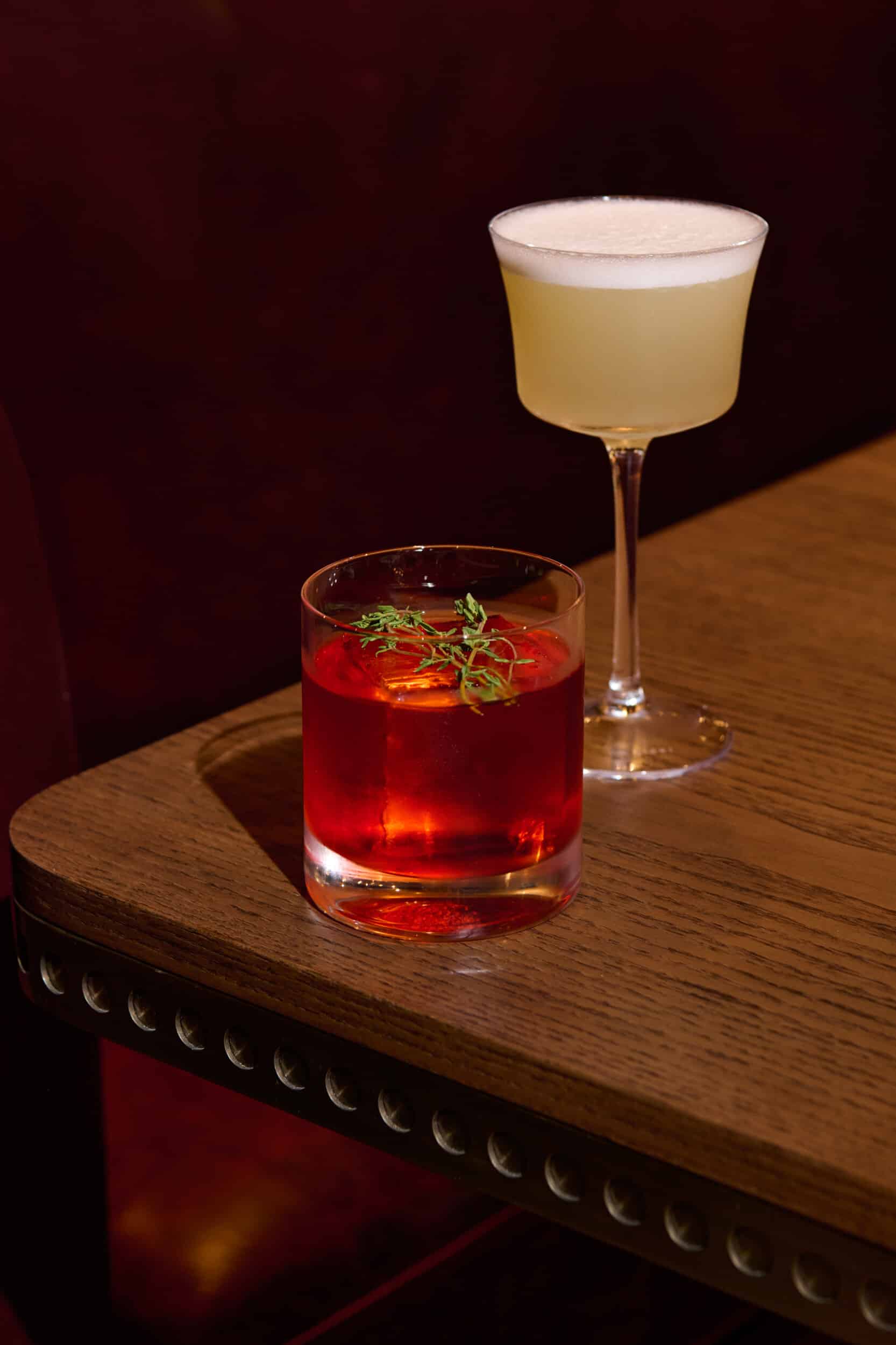 Two cocktails on a wooden table at Salt Harvest